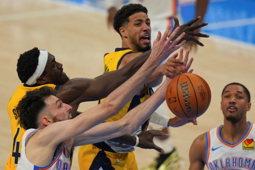 Indiana Pacers forward Pascal Siakam, Oklahoma City Thunder forward Chet Holmgren, left, and Indiana Pacers guard Tyrese Haliburton, center, battle for the rebound during the second half of Game 5 of the NBA Finals basketball series, Monday, June 16, 2025, in Oklahoma City. (AP Photo/Nate Billings)