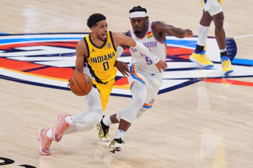 Indiana Pacers guard Tyrese Haliburton (0) drives past Oklahoma City Thunder guard Luguentz Dort (5) during the second half of Game 5 of the NBA Finals basketball series, Monday, June 16, 2025, in Oklahoma City. (AP Photo/Kyle Phillips)