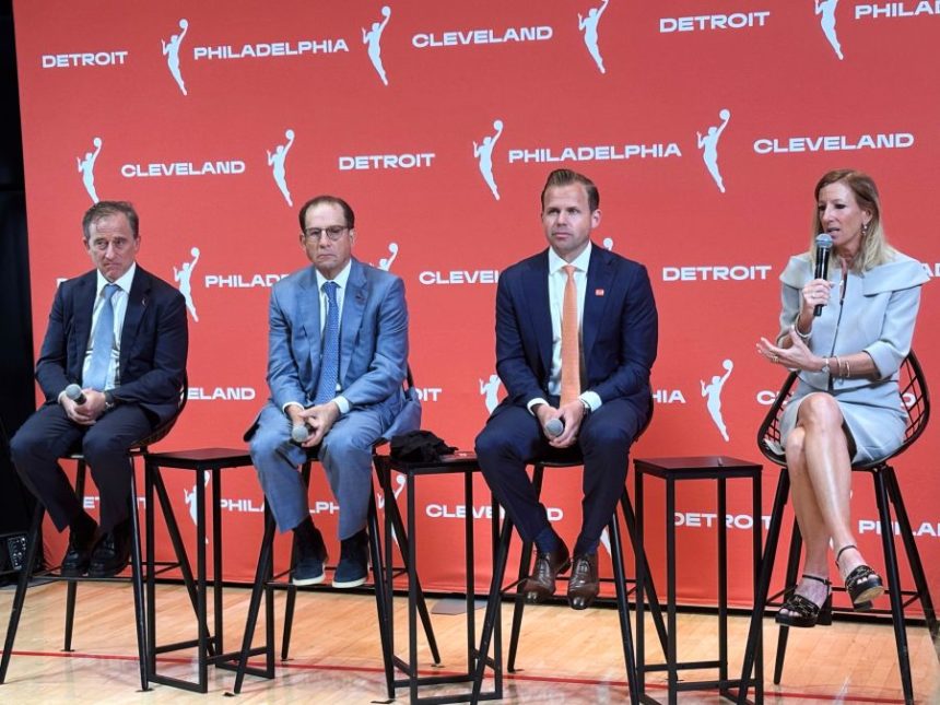Josh Harris, left, managing partner of the Philadelphia 76ers, Arn Tellem, Detroit Pistons vice chairman, Nic Barlage, representing the Cleveland Cavaliers, listen as WNBA commissioner Cathy Engelbert speaks during a news conference, Monday, June 30, 2025, in New York, announcing WNBA basketball expansion teams in Philadelphia, Detroit and Cleveland. (AP Photo/Doug Feinberg)