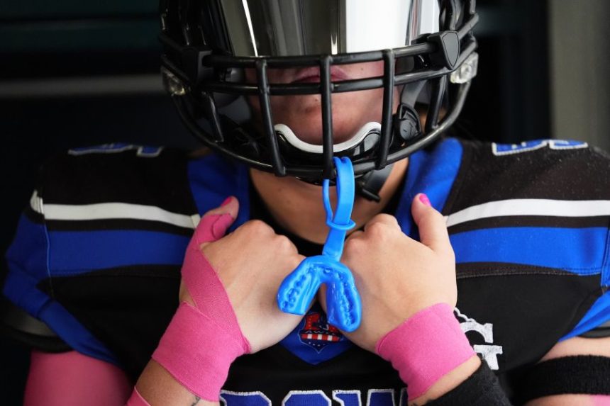 Detroit Prowl's Sydney Hebel waits in the locker room to take the field before an AWFL women's football game against the Lansing Legacy in Allen Park, Mich., Saturday, May 10, 2025. (AP Photo/Paul Sancya)