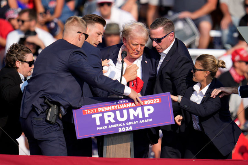 Republican presidential candidate former President Donald Trump is helped off the stage at a campaign event in Butler, Pa., July 13, 2024. | Gene J. Puskar, Associated Press