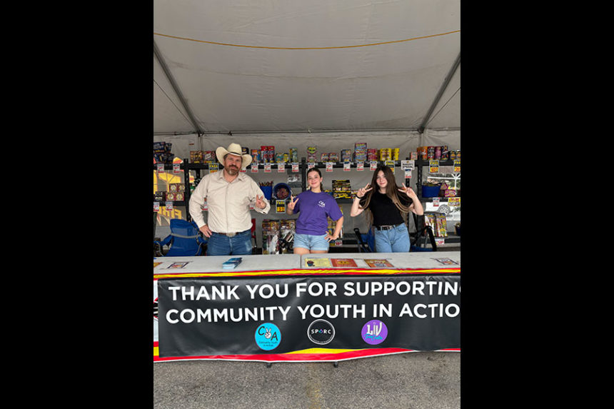 Community Youth in Action Program Director Marco Erickson with local teens at one of its firework stands | Courtesy Marco Erickson