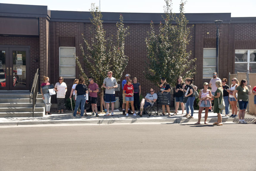 Community members and teachers of Idaho Falls School District 91 standing outside in a rally over concerns of the ongoing teacher contract negotiations. | Treydon Baylor, EastIdahoNews.com
