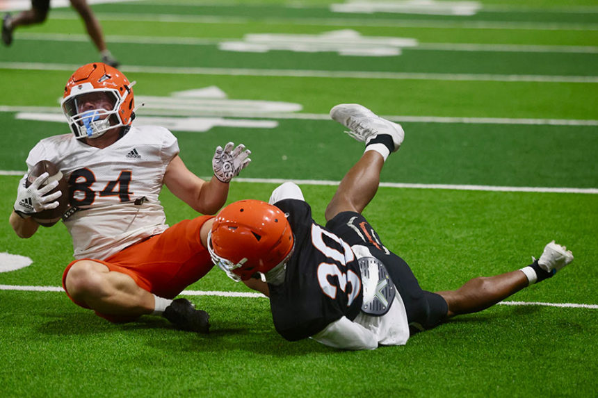 ISU football, Taylor Freeman (84) tackled by Mike Lindsay (30)