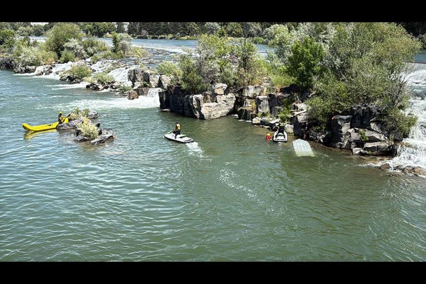 Deputies working to save two men who fell into the Snake River when their boat flipped. | Bonneville County Sheriff's Office