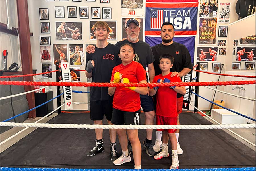 Idaho Falls Boxing Club owners Corey Taule, center in the back, with Edgar Chavez, right in back, and other club members | Rett Nelson, EastIdahoNews.com