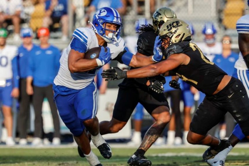 BYU running back LJ Martin is tackled by Central Florida defenders during a a game last season in Orlando, Fla. | Kevin Kolcynski, Associated Press.