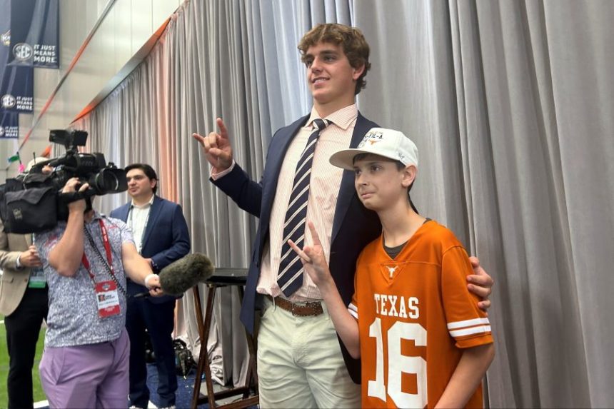 CORRECTS TO PETROZIELLO INSTEAD OF PETROZLELLO - Texas quarterback Arch Manning meets super-fan Connor Petroziello, 13, at SEC Media Days in Atlanta, Ga., Tuesday, July 15, 2025. (AP Photo/Maura Carey)