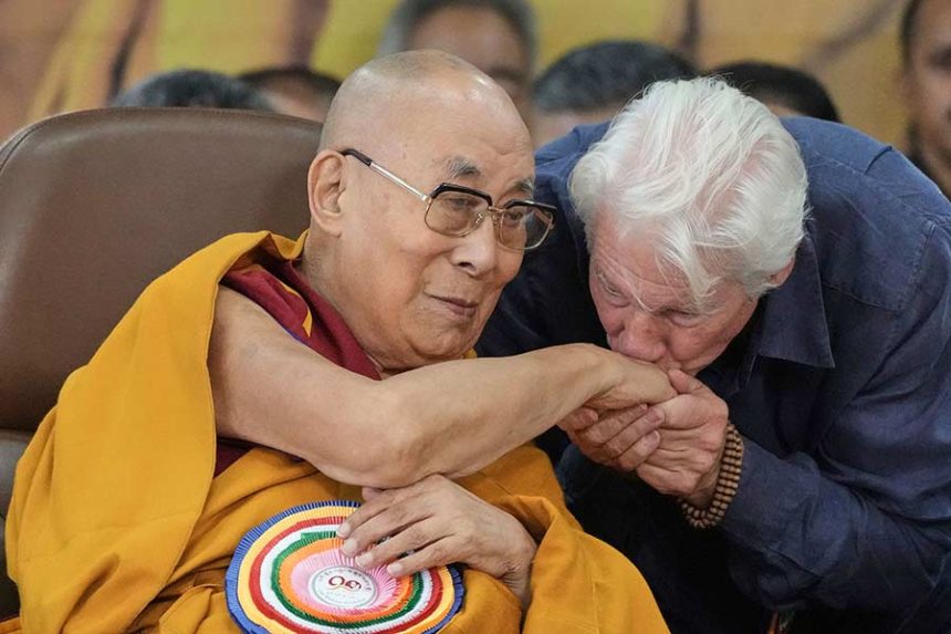 Actor Richard Gere, right, kisses the the Dalai Lama's hand at an event celebrating his 90th birthday in Dharamshala, India, on July 6. Mandatory Credit: Ashwini Bhatia/AP via CNN Newsource