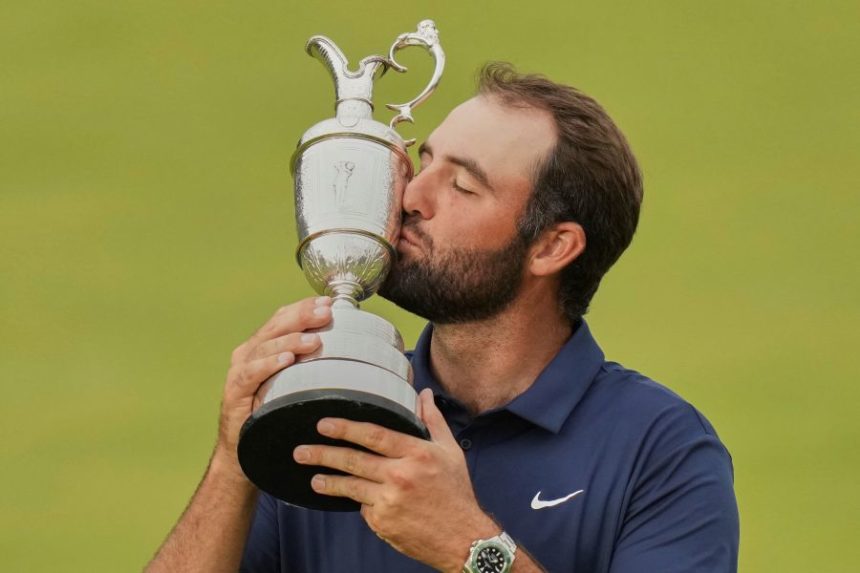 Scottie Scheffler of the United States kisses the trophy as he poses for photographers with the Claret Jug after winning the British Open golf championship at the Royal Portrush Golf Club, Northern Ireland, Sunday, July 20, 2025. (AP Photo/Francisco Seco)