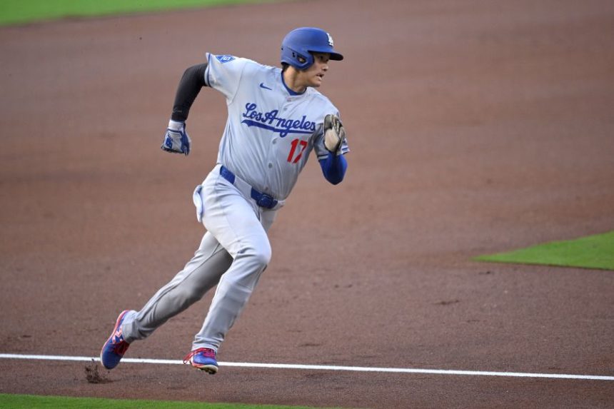 Los Angeles Dodgers' Shohei Ohtani rounds third base before scoring on a double hit by Freddie Freeman, not pictured, during the first inning of a baseball game against the San Diego Padres, Monday, June 9, 2025, in San Diego. (AP Photo/Orlando Ramirez)