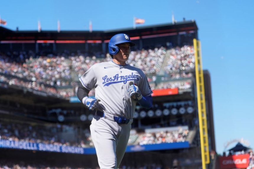 Los Angeles Dodgers' Shohei Ohtani scores against the San Francisco Giants during the 11th inning of a baseball game in San Francisco, Sunday, July 13, 2025. (AP Photo/Jeff Chiu)