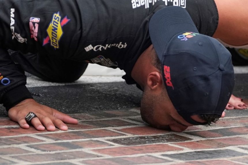 Bubba Wallace kisses the "Yard of Bricks" after winning a NASCAR Cup Series auto race at Indianapolis Motor Speedway, Sunday, July 27, 2025, in Indianapolis. (AP Photo/Darron Cummings)
