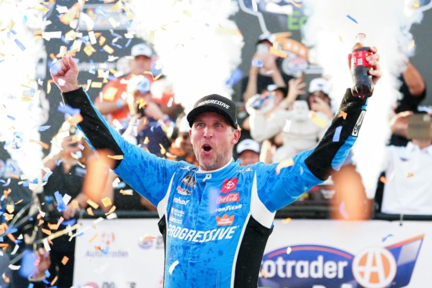 Denny Hamlin celebrates in Victory Lane after winning a NASCAR Cup Series auto race at Dover Motor Speedway, Sunday, July 20, 2025, in Dover, Del. (AP Photo/Derik Hamilton)