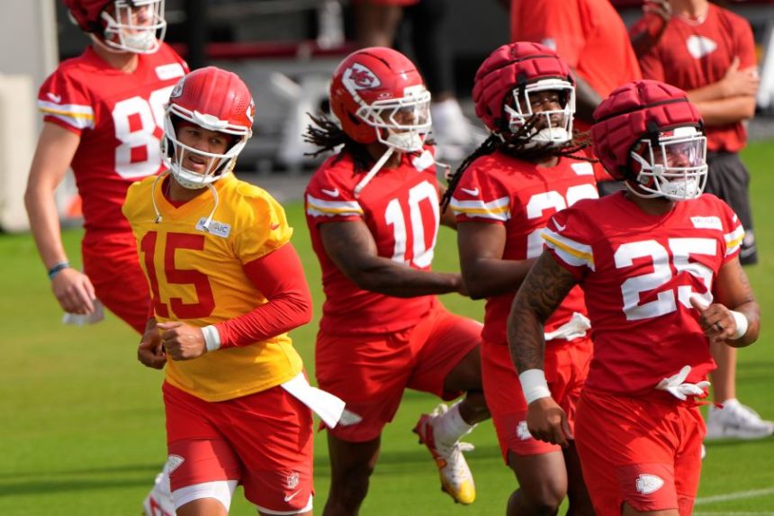 Kansas City Chiefs quarterback Patrick Mahomes (15) runs with teammates at NFL football training camp Tuesday, July 22, 2025, in St. Joseph, Mo. (AP Photo/Charlie Riedel)