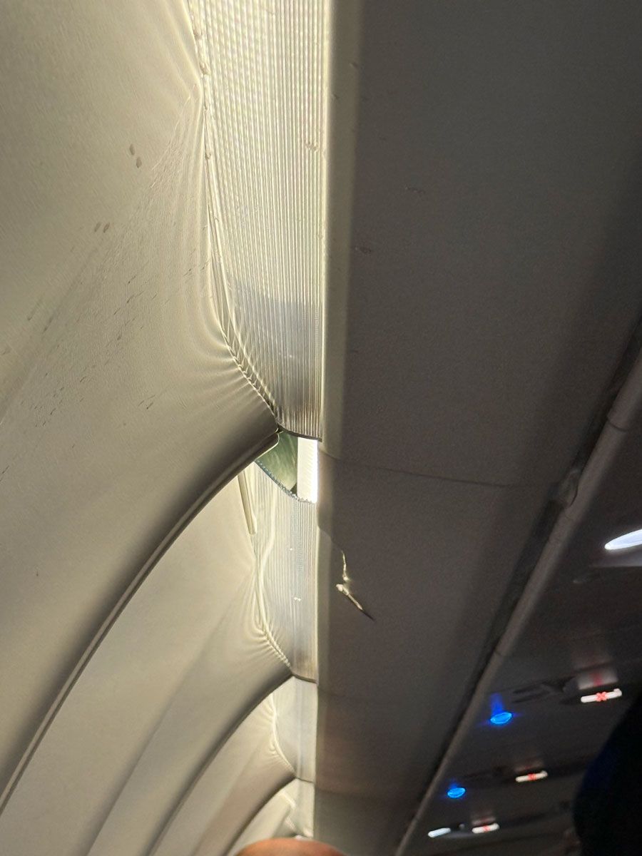 The overhead bin that was cracked by a passenger's head. | Courtesy of Andrew Schneider.