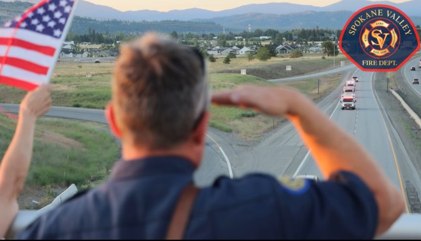 A fellow emergency responder salutes ambulances that joined a procession from Kootenai Health in Coeur d’Alene to Spokane after a gunman opened fire on firefighters responding to a brush fire at Canfield Mountain in North Idaho. Courtesy Spokane Valley Fire Department