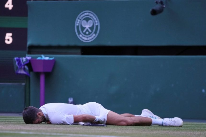 Serbia's Novak Djokovic reacts after slipping and falling when attempting a return to Italy's Flavio Cobolli during a quarterfinal men's singles match at the Wimbledon Tennis Championships in London, Wednesday, July 9, 2025. (AP Photo/Kin Cheung)