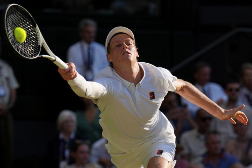 Italy's Jannik Sinner returns to Serbia's Novak Djokovic in a men's singles semifinal at the Wimbledon Tennis Championships in London, Friday, July 11, 2025. (AP Photo/Kin Cheung)