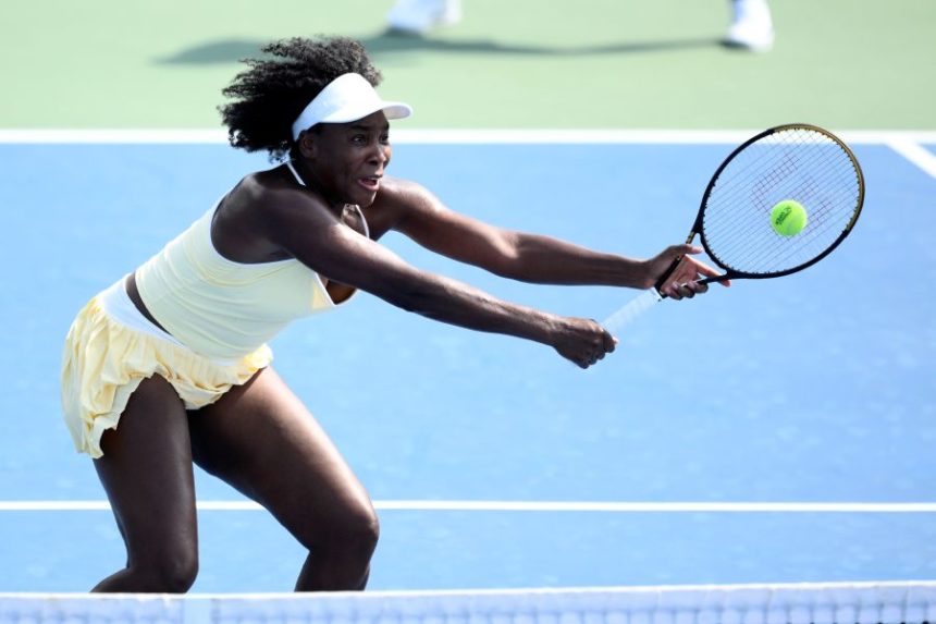 Venus Williams reaches for the ball during a doubles match with Hailey Baptiste against Eugenie Bouchard and Clervie Ngounoue at the Citi Open tennis tournament Monday, July 21, 2025, in Washington. (AP Photo/Nick Wass)