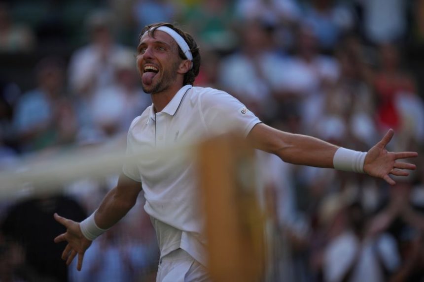 Arthur Rinderknech of France celebrates after beating Alexander Zverev of Germany in their first round men's singles match at the Wimbledon Tennis Championships in London, Tuesday, July 1, 2025. (AP Photo/Kin Cheung)