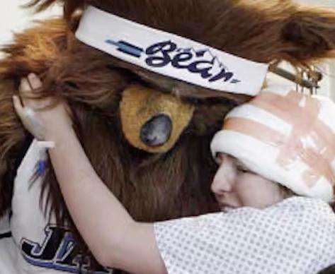Jon Absey, as the Jazz Bear, hugs a patient at Primary Children's Hospital. | Jon Absey via Instagram