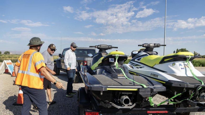 Watercraft inspector Mark Klug, left, inspects two jet skis last used in Nevada at a watercraft boat inspection station in Marsing, Friday, July 25, 2025. Sarah A. Miller, Idaho Statesman