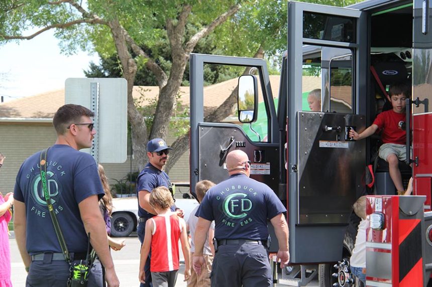 Chubbuck Firefighters monitor children as they play on their newest firetruck.