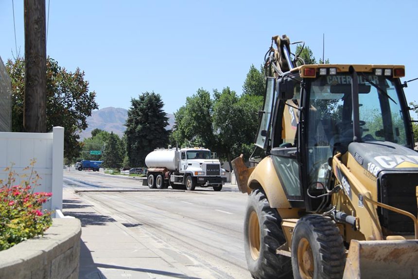A city of Chubbuck vehicle goes around the area of road where the water line breakage occured. | Logan Ramsey, EastIdahoNews.com