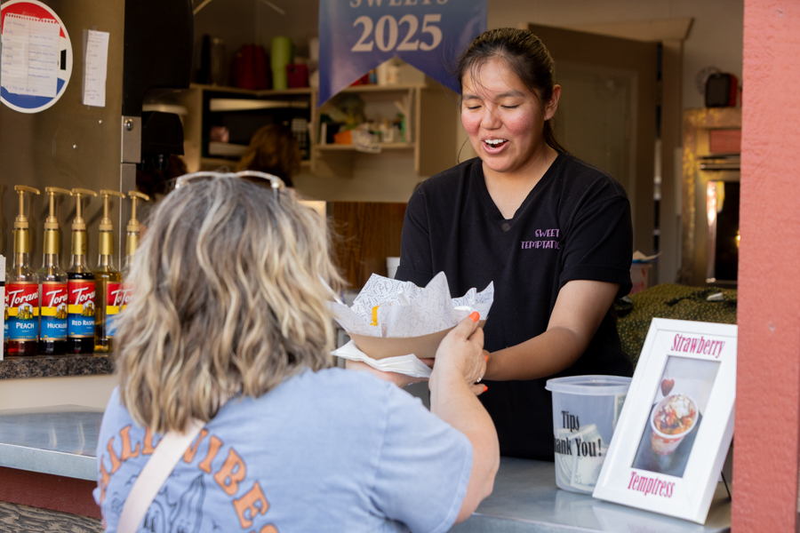 A worker at Sweet Temptations handing a community member a plate of food. | Daniel V. Ramirez, EastIdahoNews.com