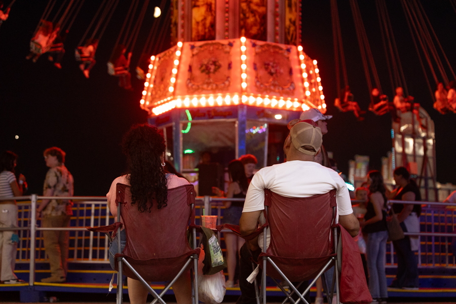 A couple sitting back, watching fair riders swing by | Daniel V. Ramirez, EastIdahoNews.com