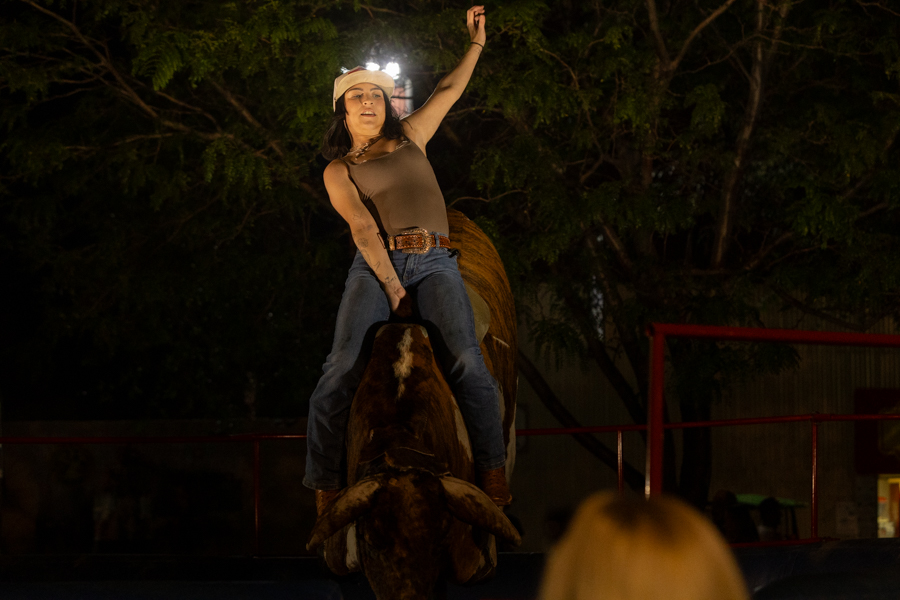 A woman holding on during a mechanical bull ride. | Daniel V. Ramirez, EastIdahoNews.com