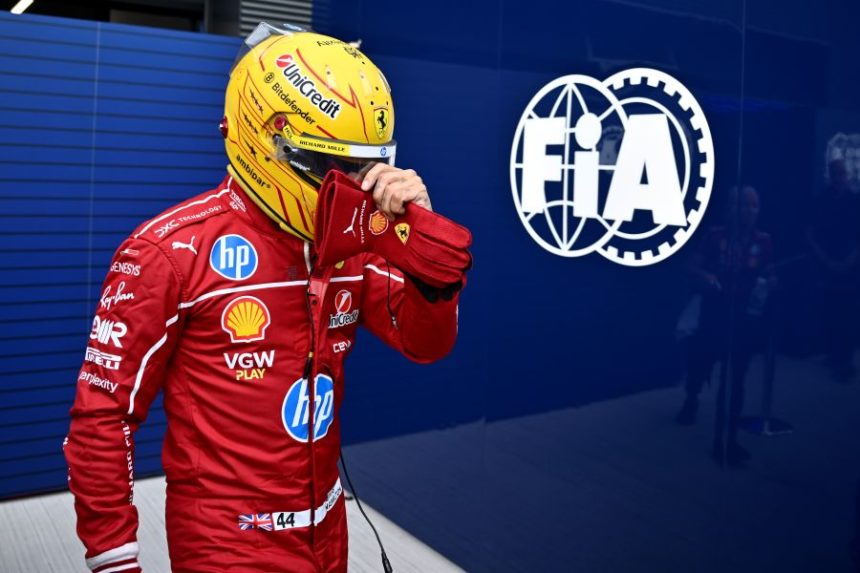 Ferrari driver Lewis Hamilton of Britain walks back to his pits after failing to complete during the qualifying session for the Hungarian Formula One Grand Prix at the Hungaroring racetrack in Mogyorod, Hungary, Saturday, Aug. 2, 2025. (AP Photo/Denes Erdos)