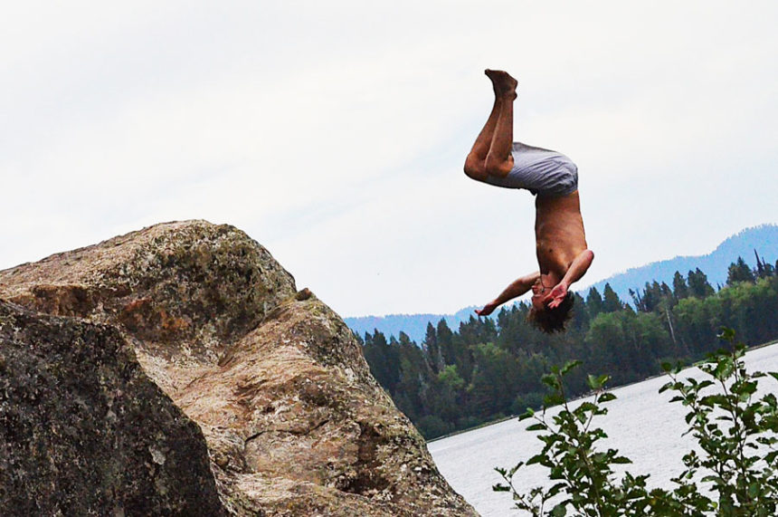 A young man doing a flip off the 40-foot Rock on Phelps Lake. | Bill Schiess