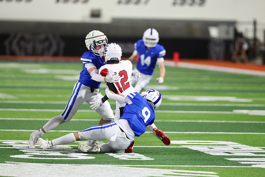 Sho-Ban football QB Zane Tohtsoni sacked by Rockland defenders Ty Woodworth and Zach Permann