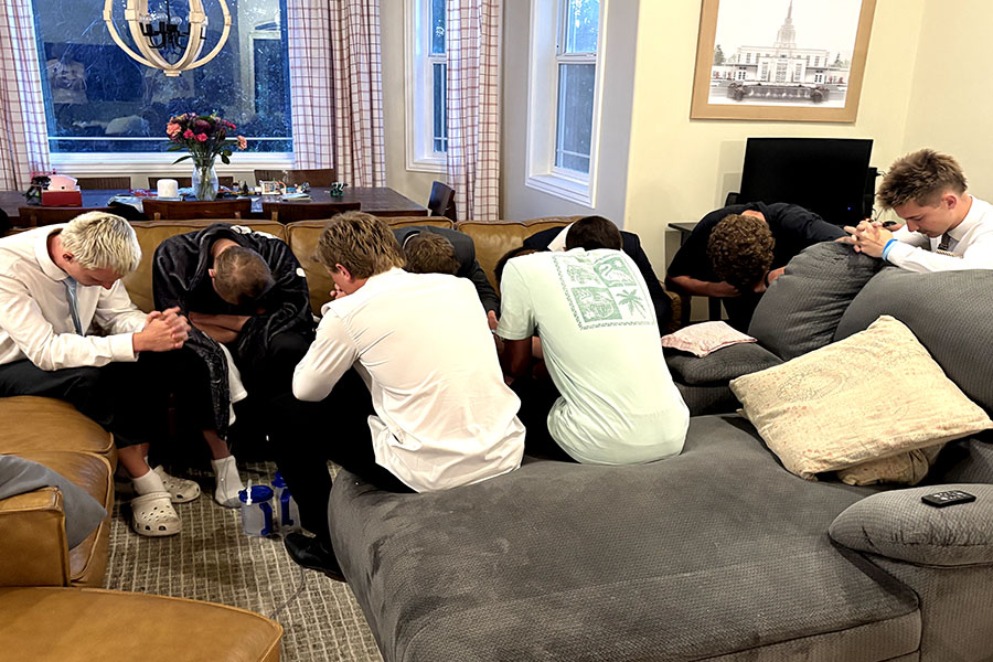 Tanner Scoresby and his friends praying together.