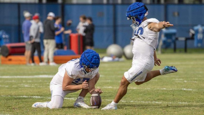 Boise State kicker Jarret Reeser, with punter Oscar Doyle holding, attempts a field goal during practice last week. The Broncos are not sure who their opening-day kicker will be. Darin Oswald doswald@idahostatesman.com