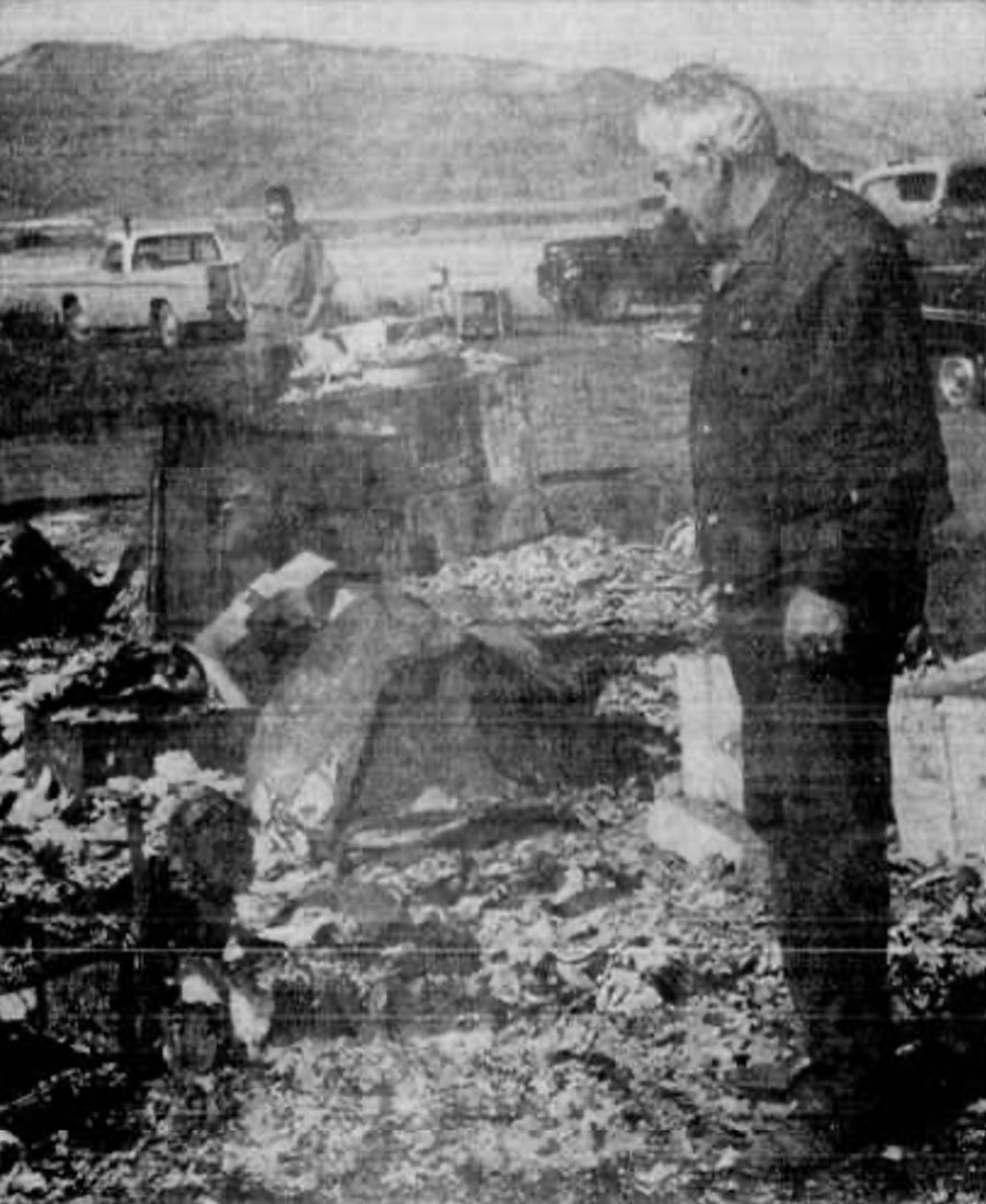 A.Y. Green, Teton County deputy sheriff and coroner, casts a grief-stricken glance at the charred remains of a four-room home that burned five Victor residents to their death. They apparently died Wednesday night before anyone noticed the home on fire, and efforts to fight the blaze were in vain.
