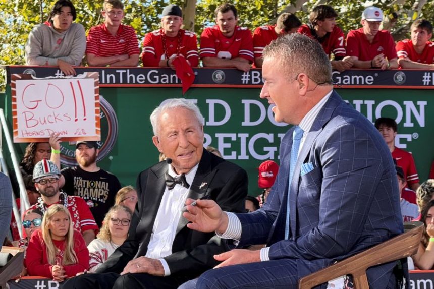 Lee Corso, right, and Kirk Herbstreit work on the set of ESPN's "College GameDay," before the NCAA college football game between Ohio State and Texas, Saturday, Aug. 30, 2025, in Columbus, Ohio (AP Photo/Jospeh Reedy)