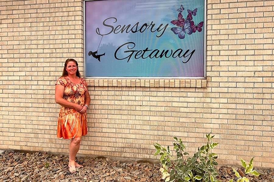 Dayna Robertson in front of the sign in front the building | Rett Nelson, EastIdahoNews.com
