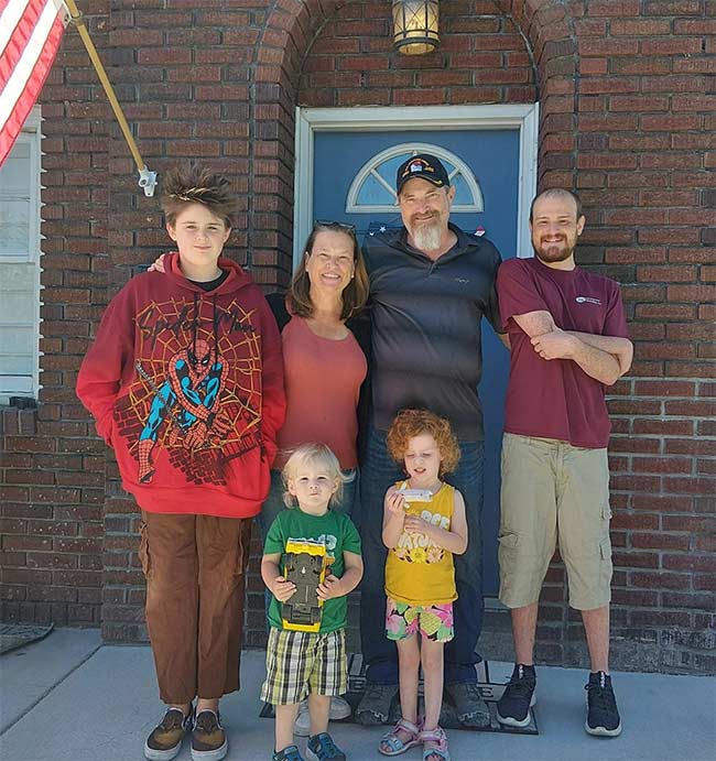 Teresa and Jared Dominick, back center, pictured with their 14-year-old son, Lane, on the left, and 33-year-old Sheldon, right. Their two grandkids, Donovan and Annabelle, are pictured on the front row. | Courtesy Dominick Family