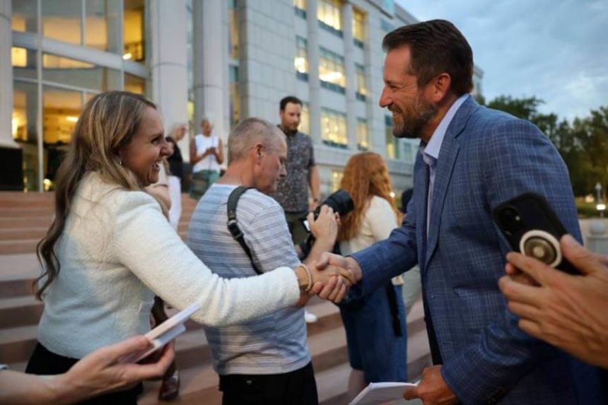 Eyi and Ball shake hands