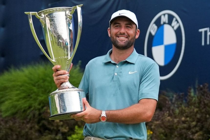Scottie Scheffler holds the trophy after winning the BMW Championship golf tournament Sunday, Aug. 17, 2025, in Owings Mills, Md. (AP Photo/Stephanie Scarbrough)