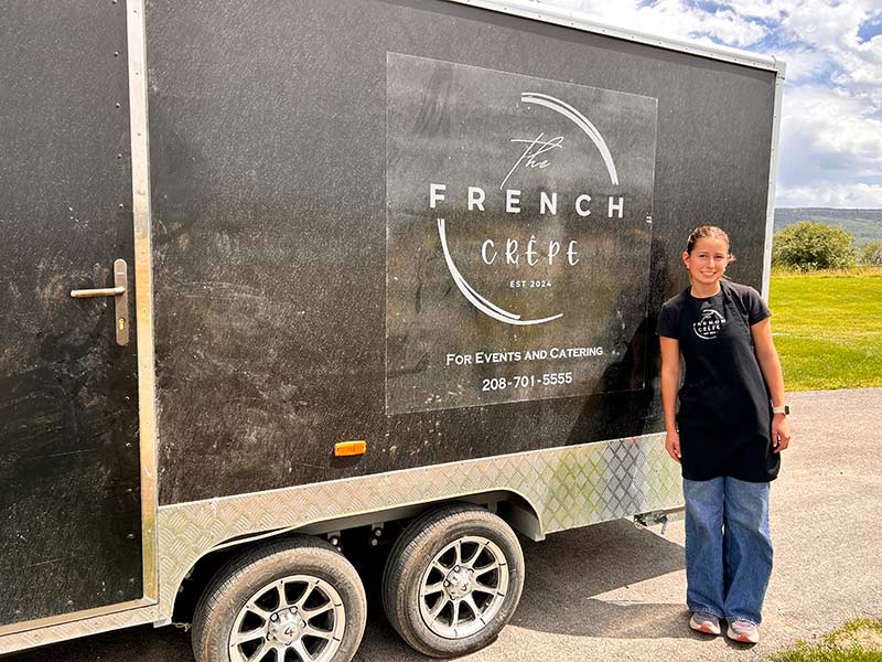 Isabella Mayberry poses for a photo outside her food trailer. | Rett Nelson, EastIdahoNews.com