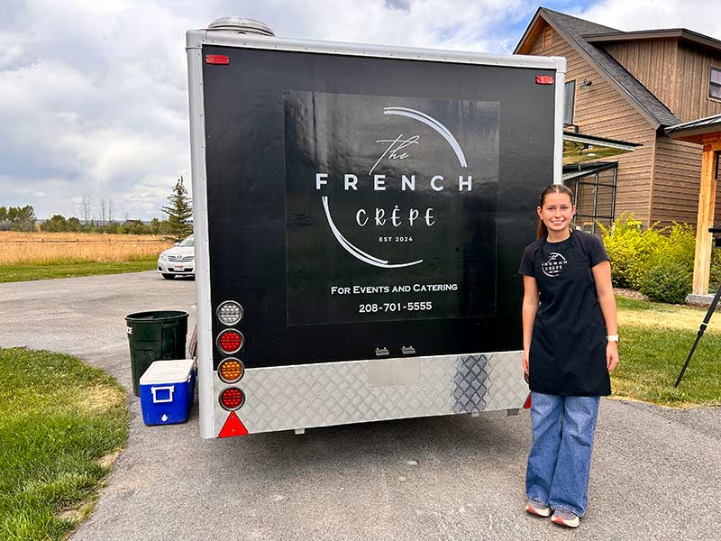 Isabella Mayberry in front of her trailer. | Rett Nelson, EastIdahoNews.com