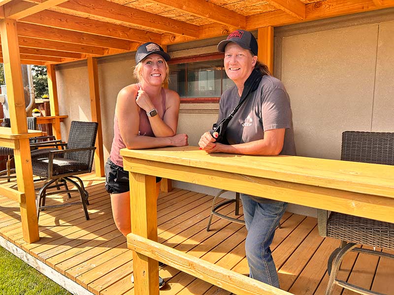 Marcye Gifford, left, and Jullie Hill pose for a photo in the outdoor seating area at Cozy Subs. | Rett Nelson, EastIdahoNews.com
