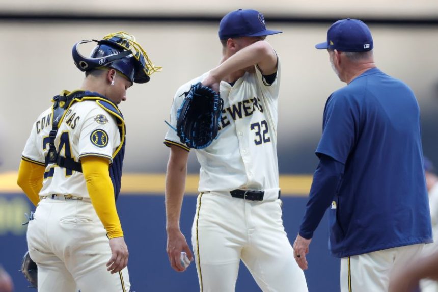 Milwaukee Brewers pitcher Jacob Misiorowski (32) wipes his face during a break in the action against the Chicago Cubs during the first inning of a baseball game, Monday, July 28, 2025, in Milwaukee. (AP Photo/Jeffrey Phelps)