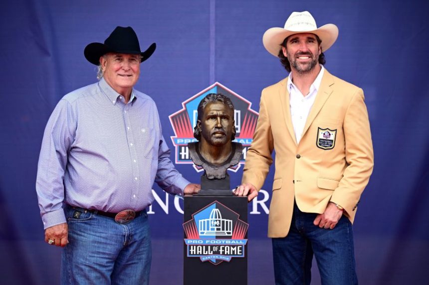 Former NFL player Jared Allen, right, accompanied by his father, Ronald Allen, pose with Jared's bust during an induction ceremony at the Pro Football Hall of Fame in Canton, Ohio, Saturday, Aug. 2, 2025. (AP Photo/David Dermer)