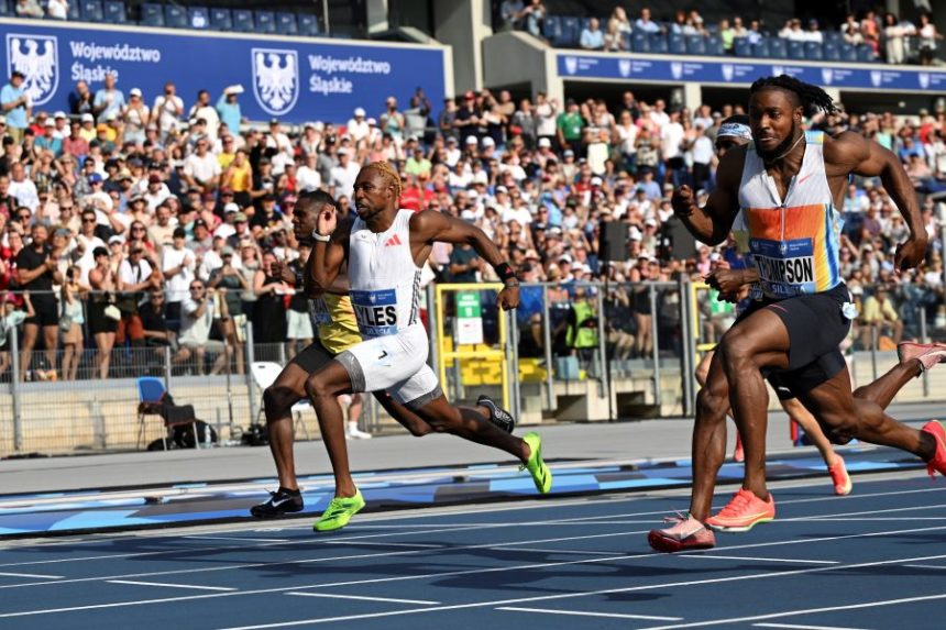 Kishane Thompson, of Jamaica, crosses the finish line ahead of Noah Lyles, of the United States, to win the men 100 meters during the Silesia Diamond League athletics meet at the Silesian Stadium, in Chorzow, Poland, Saturday, Aug. 16, 2025. (AP Photo/Rafal Oleksiewicz)
