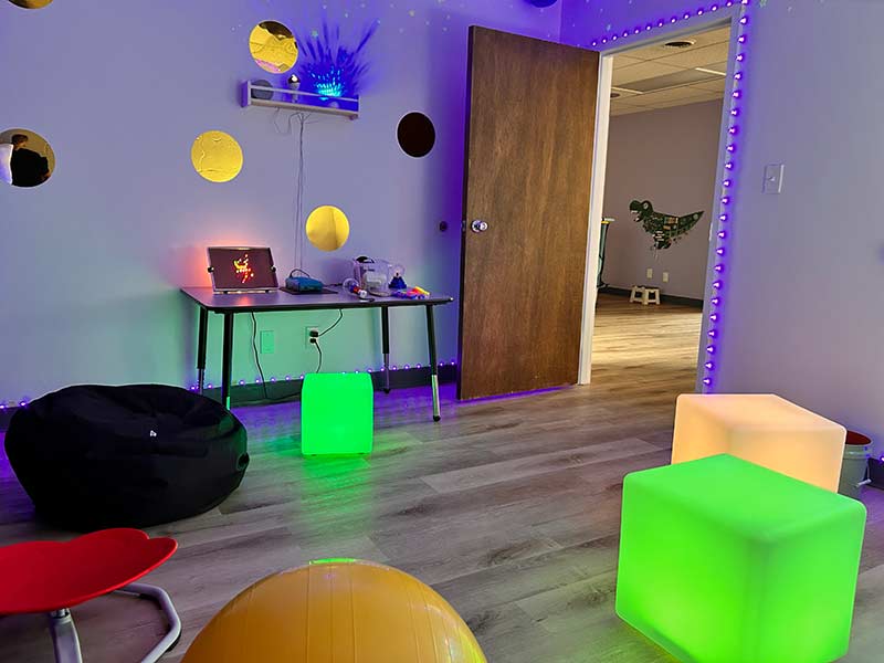 Dimly lit room at Sensory Getaway with glow-in-the-dark cubers and other toys. | Rett Nelson, EastIdahoNews.com